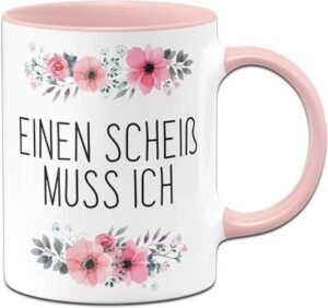 weiße Tasse mit rosa Henkel- und Innenfarbe, rosa Blütenmotiv und Text: Einen Scheiß muss ich
