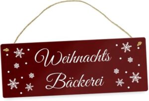 rotes Metallschild mit weißer Schrift "Weihnachts Bäckerei" und Schneekristall-Motiven
