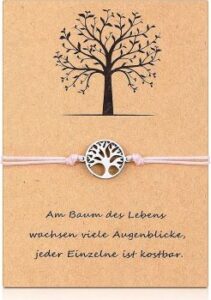 wunderschönes Armband mit rundem Lebensbaum-Motiv und rosa Bändchen auf einer Karte aus Kraftpapier
